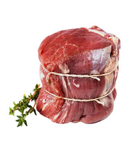 Stack of raw beef with twine on a light background